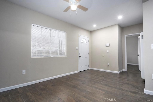 entrance foyer with ceiling fan and dark wood-type flooring