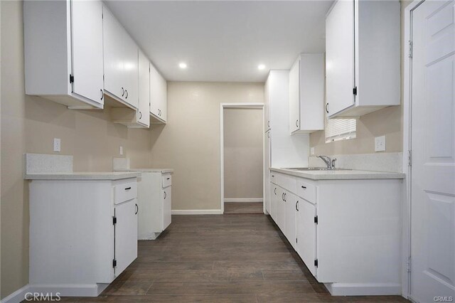 6454 Goleta Ave, Yucca Valley, CA 92284 - kitchen with a sink, recessed lighting, baseboards, white cabinetry, and dark wood-type flooring