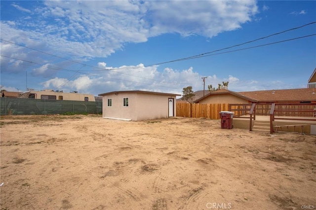 6454 Goleta Ave, Yucca Valley, CA 92284 - fenced backyard featuring a deck and an outbuilding