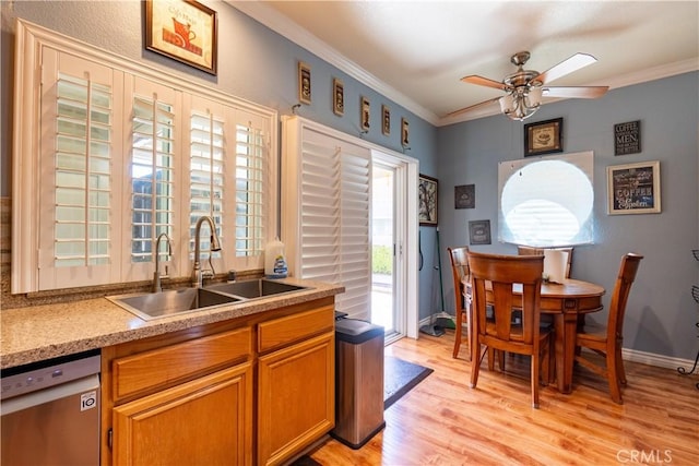 kitchen with dishwasher, light hardwood / wood-style floors, ornamental molding, and sink