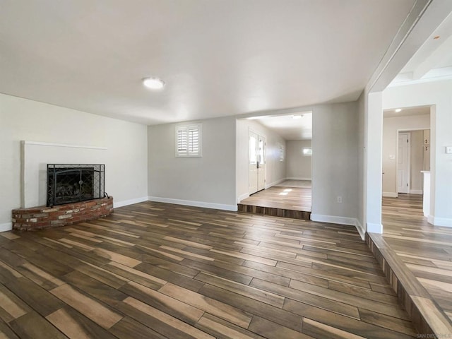 unfurnished living room with a fireplace and dark hardwood / wood-style floors