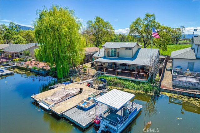 view of dock featuring a deck with water view