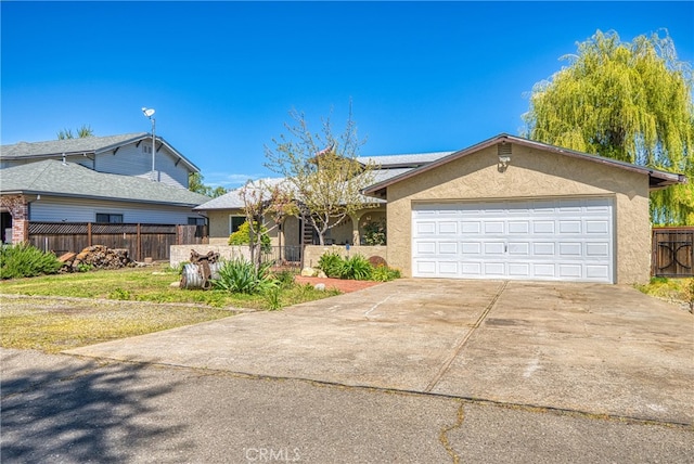 view of front of house featuring a garage and a front lawn