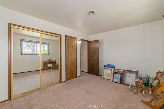 carpeted bedroom featuring a closet