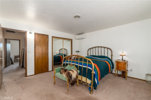 bedroom with a wall mounted AC and light carpet