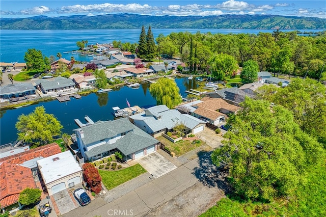 drone / aerial view with a water and mountain view