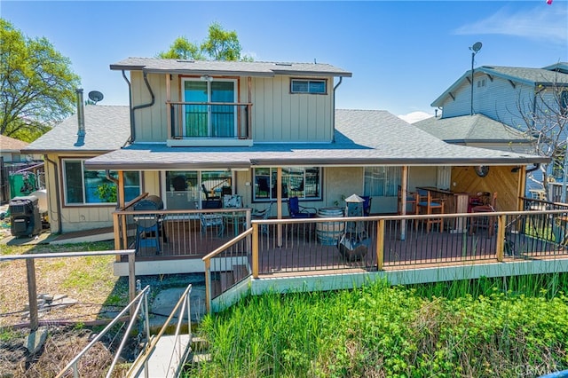 rear view of property featuring a deck