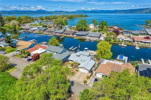 birds eye view of property featuring a water and mountain view