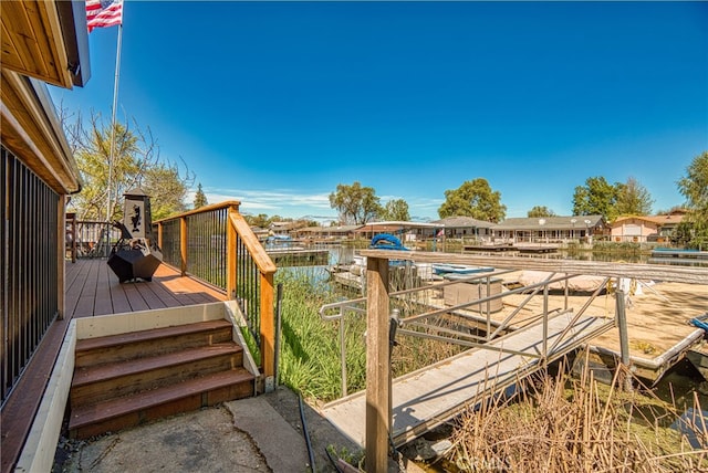 view of yard with a boat dock and a deck