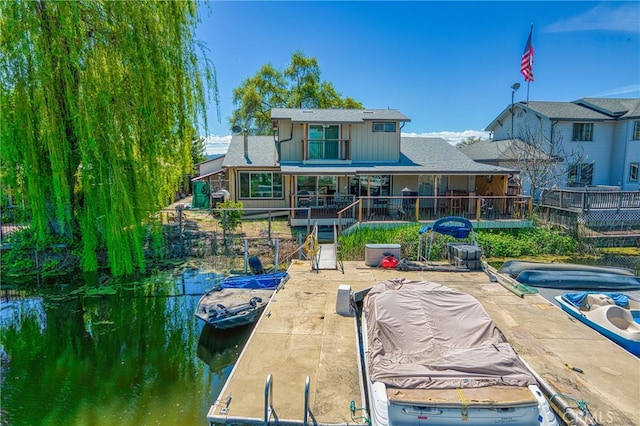 rear view of property featuring a covered pool