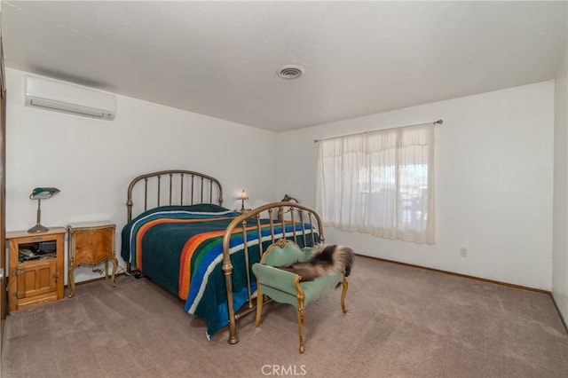 bedroom featuring a wall unit AC and light colored carpet