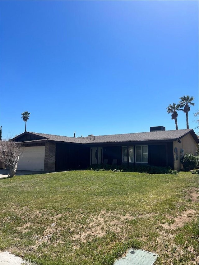 ranch-style house with a garage and a front lawn