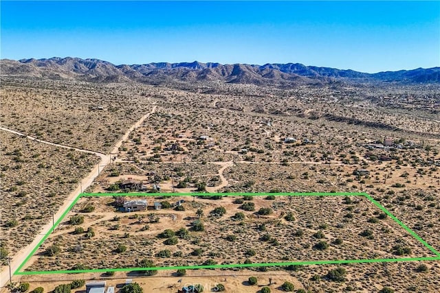 birds eye view of property featuring a mountain view