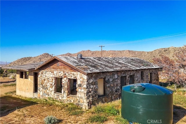 view of property exterior with a mountain view