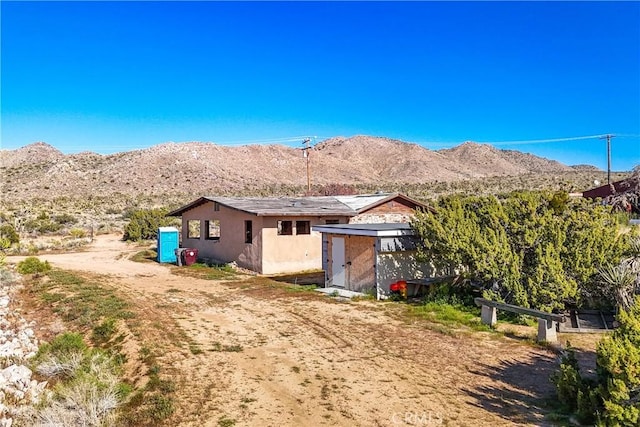 back of house featuring a mountain view