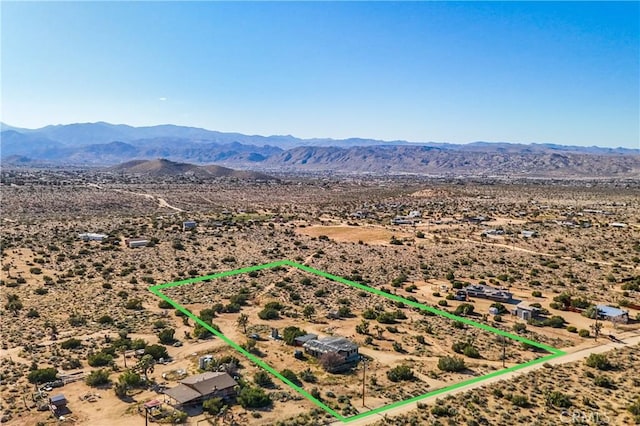 birds eye view of property with a mountain view