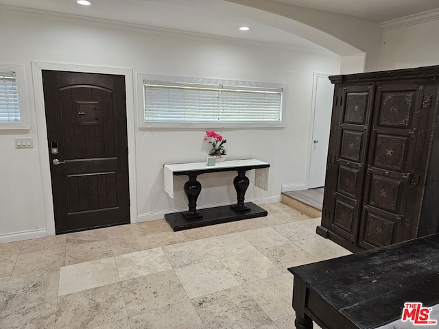 foyer featuring crown molding