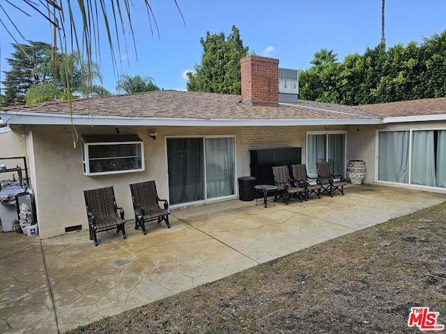 rear view of property featuring a patio area