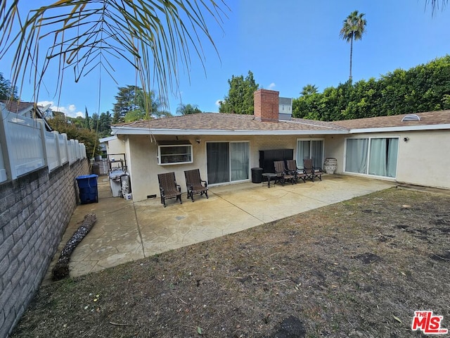 rear view of property featuring a patio