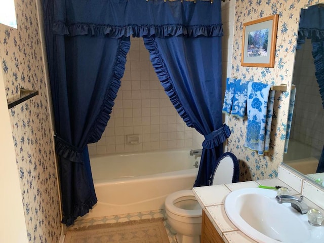 full bathroom with vanity, shower / bath combo, and toilet