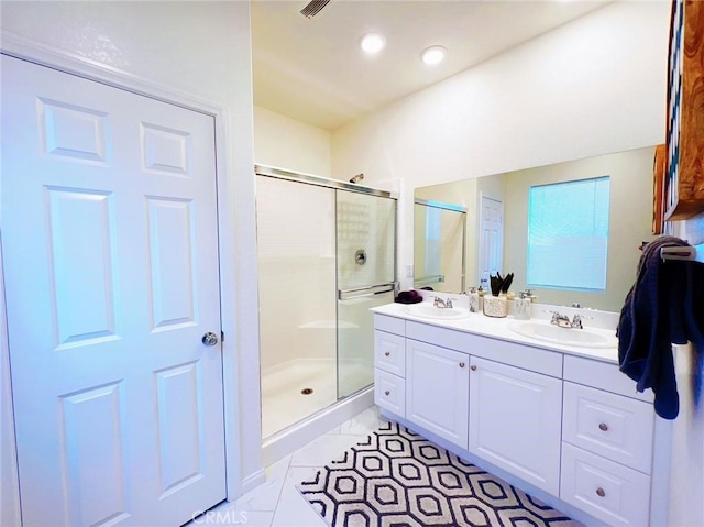 bathroom with tile patterned flooring, vanity, and an enclosed shower