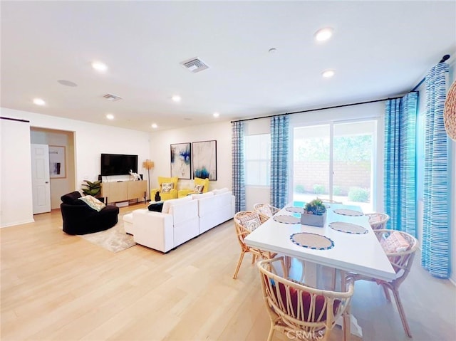 dining space with light hardwood / wood-style flooring