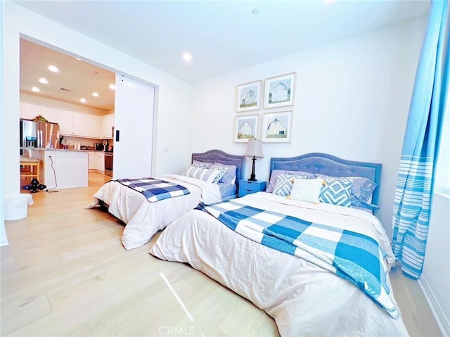 bedroom with stainless steel refrigerator with ice dispenser and light wood-type flooring