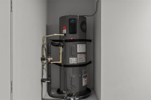 utility room featuring water heater