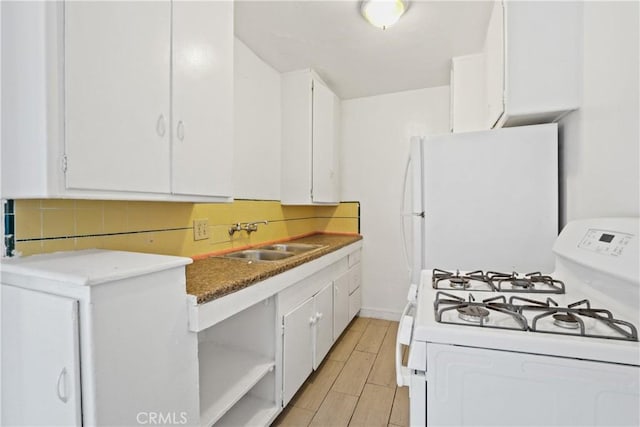 kitchen featuring backsplash, white cabinetry, white appliances, and sink