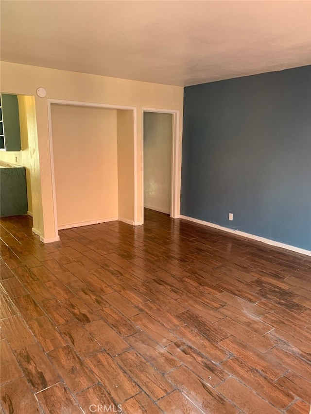 empty room with hardwood / wood-style floors