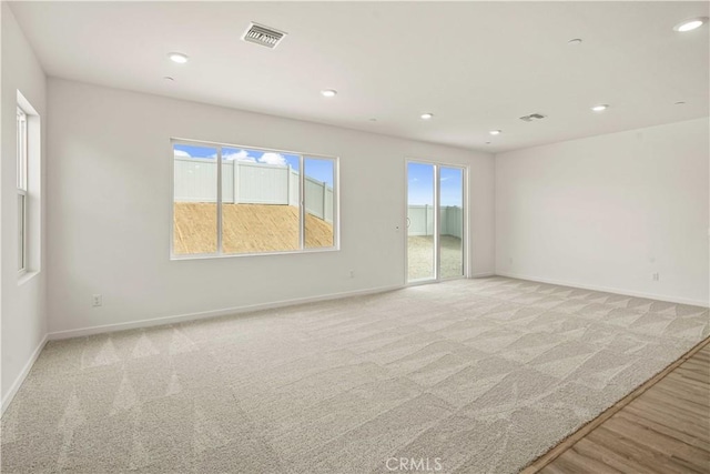 spare room with light colored carpet