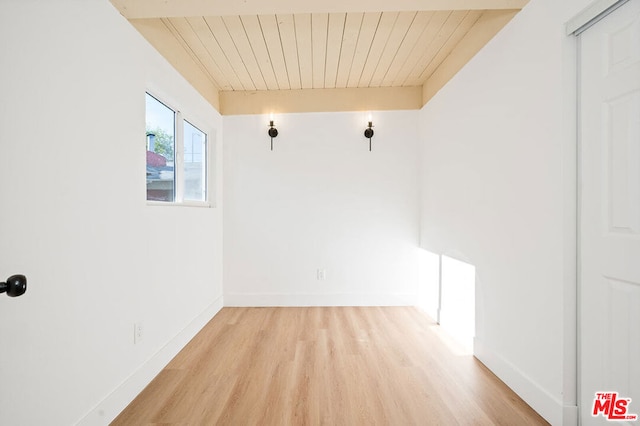 spare room featuring wood ceiling and light wood-type flooring