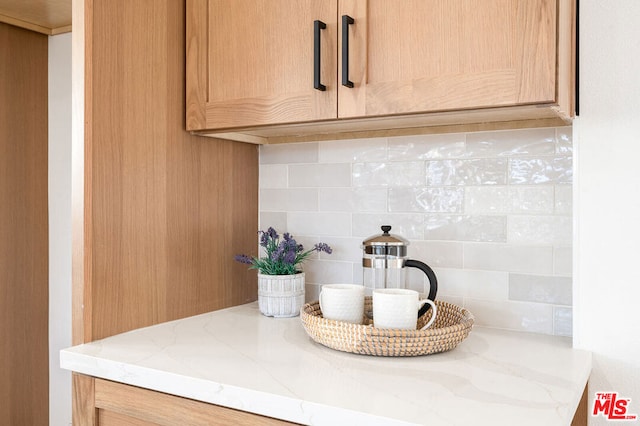 details featuring tasteful backsplash and vanity