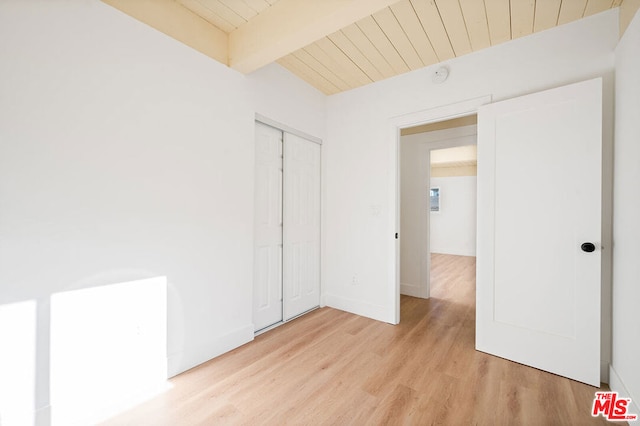 interior space featuring a closet, light hardwood / wood-style flooring, and beam ceiling