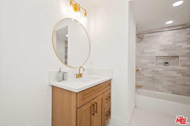 bathroom with tile flooring, oversized vanity, and tiled shower / bath combo