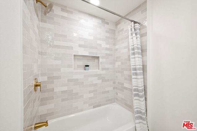 bathroom with shower / bathtub combination with curtain