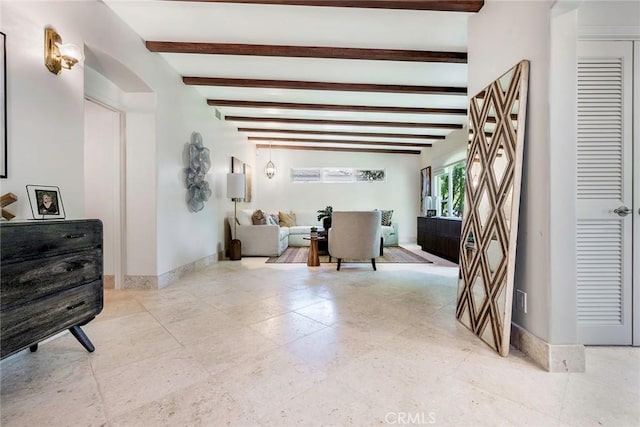 interior space featuring lofted ceiling with beams