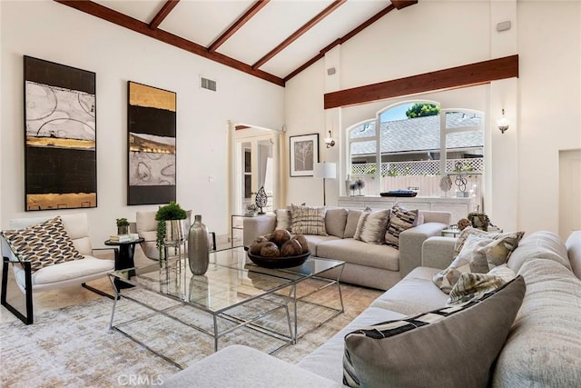 living room with beamed ceiling and high vaulted ceiling