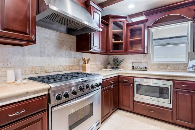 kitchen with backsplash, appliances with stainless steel finishes, extractor fan, and light tile patterned flooring