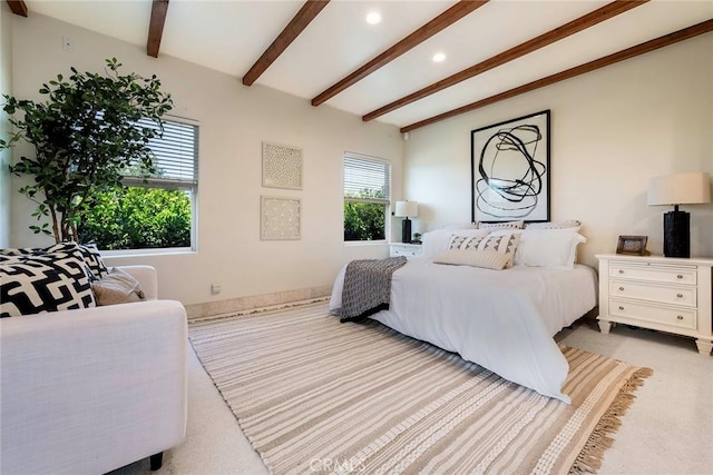 bedroom featuring light carpet and beam ceiling