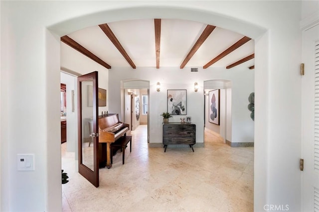 hallway featuring beamed ceiling