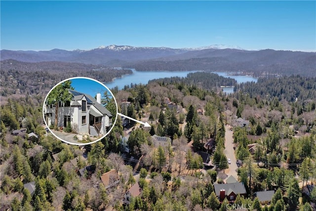 birds eye view of property featuring a water and mountain view