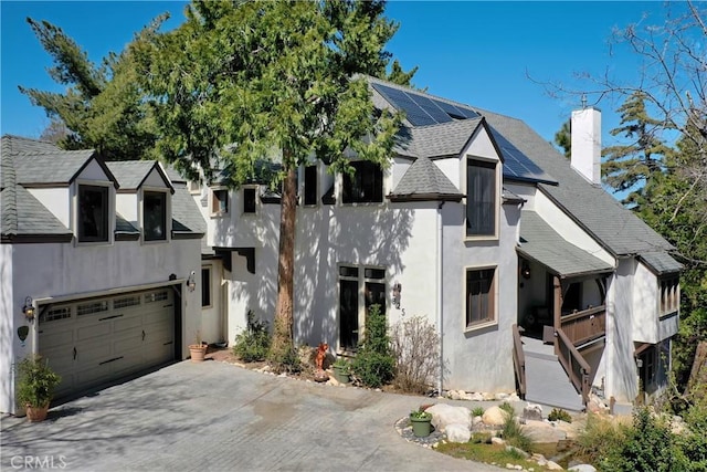 view of front of house with a garage and solar panels