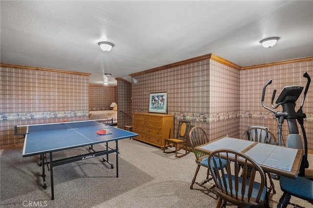 playroom with light carpet, a textured ceiling, and ornamental molding