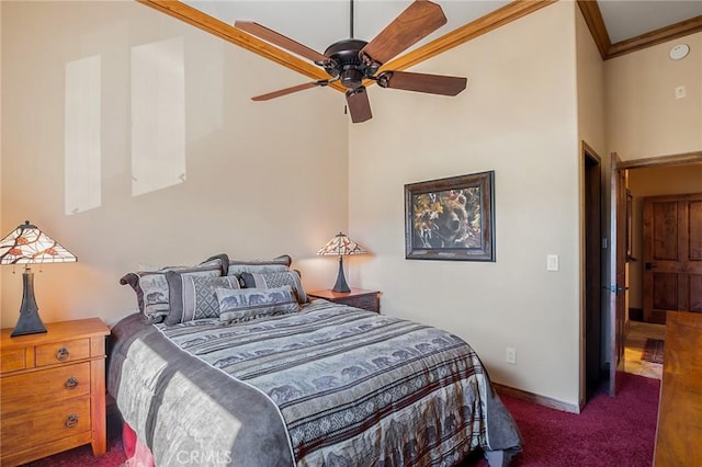 bedroom with ceiling fan, crown molding, a high ceiling, and dark colored carpet