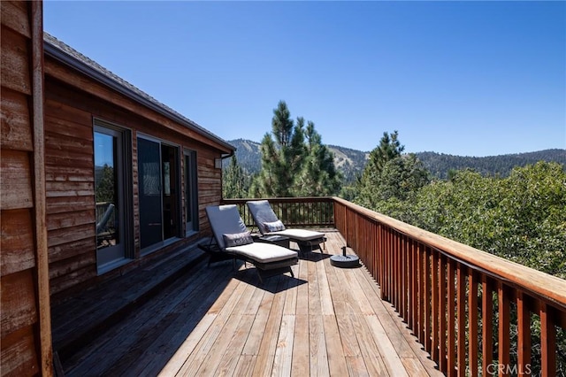 wooden deck with a mountain view