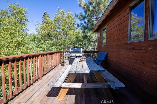 wooden terrace featuring a grill