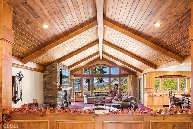 living room with vaulted ceiling with beams, a stone fireplace, and wooden ceiling