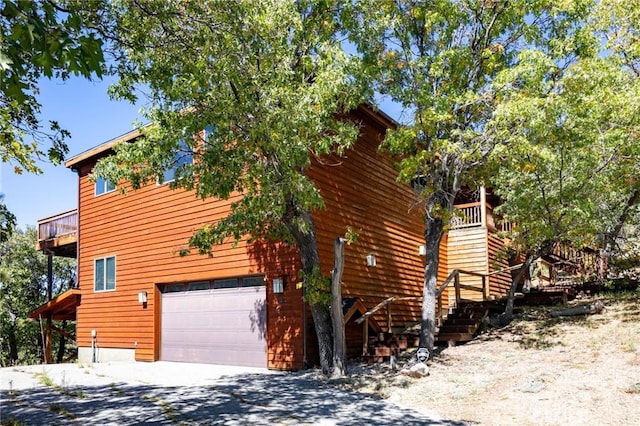 view of home's exterior with a balcony and a garage