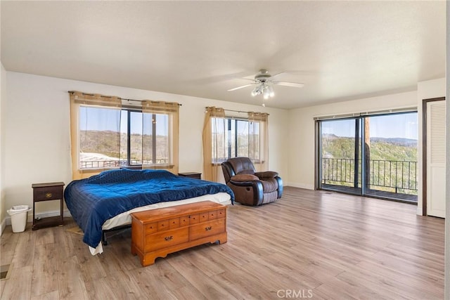 bedroom with access to outside, ceiling fan, and light hardwood / wood-style flooring